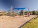 Community playground featuring a swing set, climbing wall, and covered play structure on a mulch base at 601 Golfers Vw, Pittsboro, NC 27312