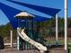 Playground with shade cover showcasing a fun slide and climbable play structure in a common outdoor area at 601 Golfers Vw, Pittsboro, NC 27312