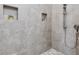 Walk-in shower featuring tiled walls, mosaic floor, and a hand shower at 601 Golfers Vw, Pittsboro, NC 27312
