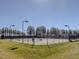Well-maintained community tennis courts enclosed by fencing with lighting for evening play at 601 Golfers Vw, Pittsboro, NC 27312
