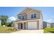 Charming two-story home with a one-car garage and manicured lawn against a bright blue sky at 6048 Sodium St, Raleigh, NC 27610