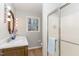 Modern bathroom featuring double sinks, a decorative mirror, and glass-enclosed shower at 6800 Chamonix Pl, Raleigh, NC 27613