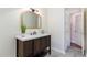 Updated bathroom with quartz counters, decorative mirror and stylish dark wood vanity at 6800 Chamonix Pl, Raleigh, NC 27613