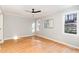 Inviting bedroom featuring hardwood floors, a ceiling fan, and large windows at 6800 Chamonix Pl, Raleigh, NC 27613