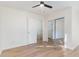Bright, minimalist bedroom with wood floors, a ceiling fan, and ample closet space at 6800 Chamonix Pl, Raleigh, NC 27613