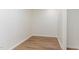 Walk-in closet featuring attractive wood flooring and natural light, great for storage at 6800 Chamonix Pl, Raleigh, NC 27613