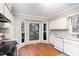 Bright eat-in kitchen with white cabinets, modern appliances, and a large bay window at 6800 Chamonix Pl, Raleigh, NC 27613