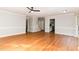 Spacious living area featuring wood floors, neutral paint, and staircase access at 6800 Chamonix Pl, Raleigh, NC 27613