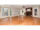 Bright living room with hardwood floors, fireplace, and large windows with natural light at 6800 Chamonix Pl, Raleigh, NC 27613