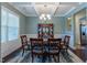 Formal dining room boasts decorative tray ceilings, wainscoting, and ample natural light at 706 Mount Ranier Dr, Mebane, NC 27302