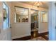 Inviting foyer with hardwood floors, decorative columns, and views into the adjacent dining room at 706 Mount Ranier Dr, Mebane, NC 27302