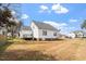 Spacious backyard with lush grass and a well-maintained white-sided house at 7201 Spanglers Spring Way, Raleigh, NC 27610