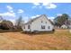 Spacious backyard with lush grass and a well-maintained white-sided house at 7201 Spanglers Spring Way, Raleigh, NC 27610