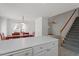 View of the dining room adjacent to the kitchen, featuring a dining table and staircase at 7201 Spanglers Spring Way, Raleigh, NC 27610