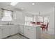 Spacious kitchen with white cabinets, dining area, and large windows offering natural light at 7201 Spanglers Spring Way, Raleigh, NC 27610