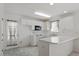 Bright kitchen featuring all-white cabinets, microwave, and a door to the backyard at 7201 Spanglers Spring Way, Raleigh, NC 27610