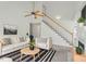 Bright living room featuring a high ceiling, modern decor, and a staircase to the second floor at 7201 Spanglers Spring Way, Raleigh, NC 27610