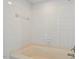 Shower with all white tilework and chrome faucet at 7201 Spanglers Spring Way, Raleigh, NC 27610