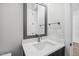 Clean bathroom featuring a vanity with modern faucet and mirror, providing a sleek and functional space at 9004 Penny Rd, Raleigh, NC 27606