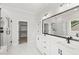 Bathroom featuring dual vanities, a large mirror, and glass enclosed walk-in showers on either side of the room at 9004 Penny Rd, Raleigh, NC 27606