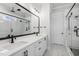 Modern bathroom featuring double vanity, black hardware, marble floors and glass shower at 9004 Penny Rd, Raleigh, NC 27606