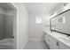 Large vanity with double sinks and modern fixtures, with grey tile at 9004 Penny Rd, Raleigh, NC 27606