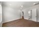 Neutral bedroom featuring hardwood floors, a ceiling fan and access to another room and ensuite bath at 9004 Penny Rd, Raleigh, NC 27606