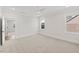 Bright bedroom with large windows, plush carpet, a ceiling fan, and access to an adjacent room at 9004 Penny Rd, Raleigh, NC 27606