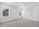 Neutral bedroom with carpet floor, ceiling fan, and two windows at 9004 Penny Rd, Raleigh, NC 27606