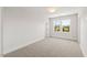 Empty bedroom with neutral carpet, two windows with view, and white paint at 9004 Penny Rd, Raleigh, NC 27606