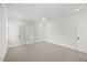 Spacious bedroom with plush carpet, neutral paint, a ceiling fan, and direct access to a private bathroom at 9004 Penny Rd, Raleigh, NC 27606