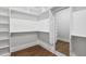 Walk-in closet with custom shelving and wood floor at 9004 Penny Rd, Raleigh, NC 27606