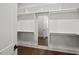 Walk-in closet with built-in shelving and a view to another room through a mirrored door at 9004 Penny Rd, Raleigh, NC 27606