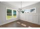 Sunlit dining room with hardwood floors and views of the outdoors at 9004 Penny Rd, Raleigh, NC 27606