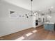 Dining area with hardwood floors, modern light fixture, and wainscoting at 9004 Penny Rd, Raleigh, NC 27606
