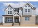 Charming new home with gray siding, brick, and a covered porch, creating a welcoming entrance at 9004 Penny Rd, Raleigh, NC 27606