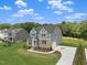 Charming two-story home with gray siding, lush lawn, and a convenient driveway at 9004 Penny Rd, Raleigh, NC 27606