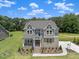Beautiful two-story home with gray siding, manicured lawn, and inviting front entrance at 9004 Penny Rd, Raleigh, NC 27606