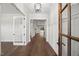Elegant foyer with hardwood floors, white trim, and natural light at 9004 Penny Rd, Raleigh, NC 27606