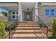 Inviting front entrance with brick steps and a stylish wood door at 9004 Penny Rd, Raleigh, NC 27606