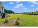 View of the lawn from the front of the home; manicured shrubs accent the landscaping at 9004 Penny Rd, Raleigh, NC 27606