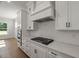 Modern kitchen with white cabinetry, stainless steel appliances, and a herringbone backsplash at 9004 Penny Rd, Raleigh, NC 27606