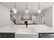 Open concept kitchen with island sink, white countertops, and view of the living area at 9004 Penny Rd, Raleigh, NC 27606