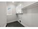Well lit laundry room with ample storage space and a stylish tile floor at 9004 Penny Rd, Raleigh, NC 27606