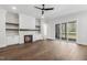 Cozy living room featuring a fireplace with built-in shelving and sliding glass doors to a deck at 9004 Penny Rd, Raleigh, NC 27606