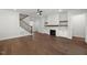 Bright living room featuring hardwood floors, a fireplace, and stairway at 9004 Penny Rd, Raleigh, NC 27606