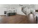Spacious open-concept living room featuring hardwood floors and modern staircase at 9004 Penny Rd, Raleigh, NC 27606