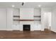 Cozy living room with a fireplace, built-in shelving, and hardwood floors at 9004 Penny Rd, Raleigh, NC 27606
