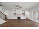 Open living room with a fireplace, built-in shelving, and sliding glass doors at 9004 Penny Rd, Raleigh, NC 27606