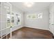 Bright office with hardwood floors, multiple windows, and a glass-paneled door at 9004 Penny Rd, Raleigh, NC 27606